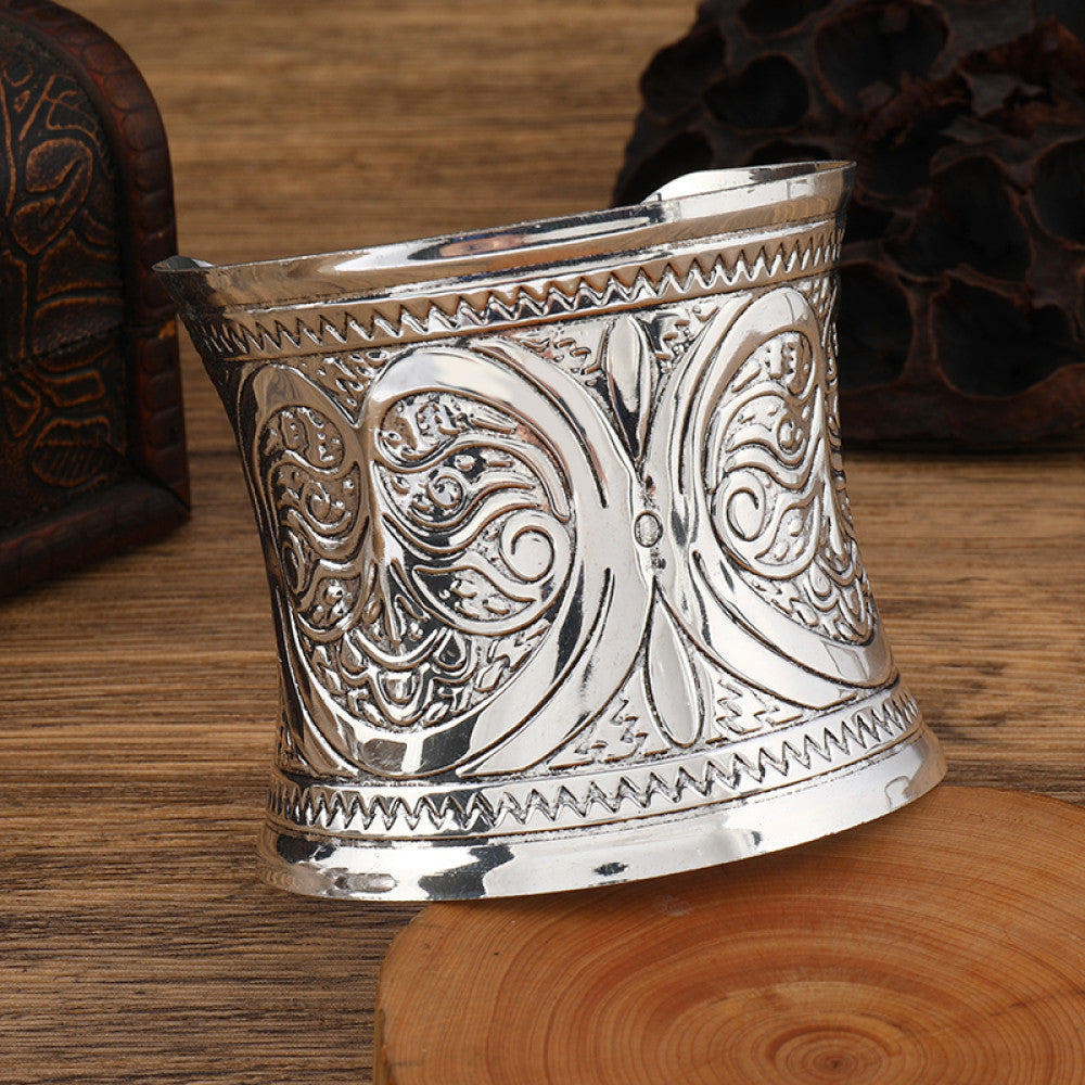Boho vintage ethnic engraved silver cuff bangle with intricate floral designs, styled on wooden surface, ideal for bohemian and tribal fashion enthusiasts in the US 06