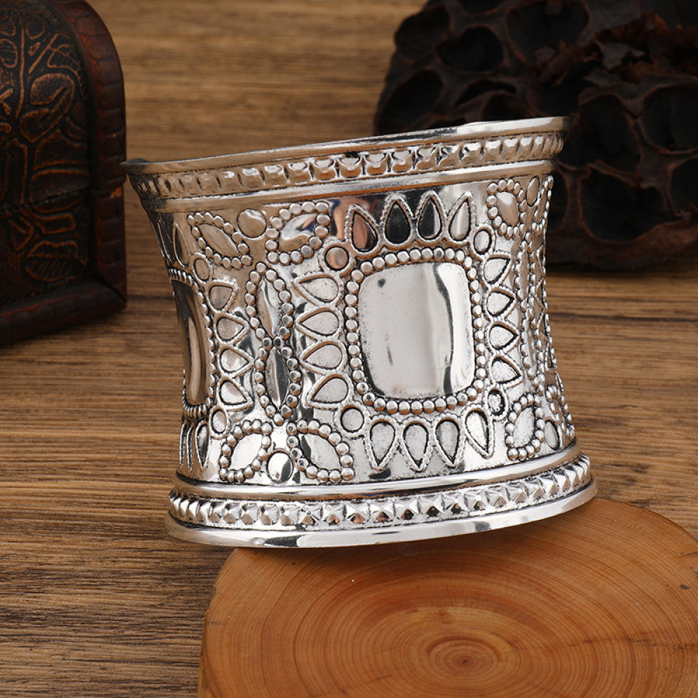Boho vintage ethnic engraved silver cuff bangle with intricate floral designs, styled on wooden surface, ideal for bohemian and tribal fashion enthusiasts in the US 08
