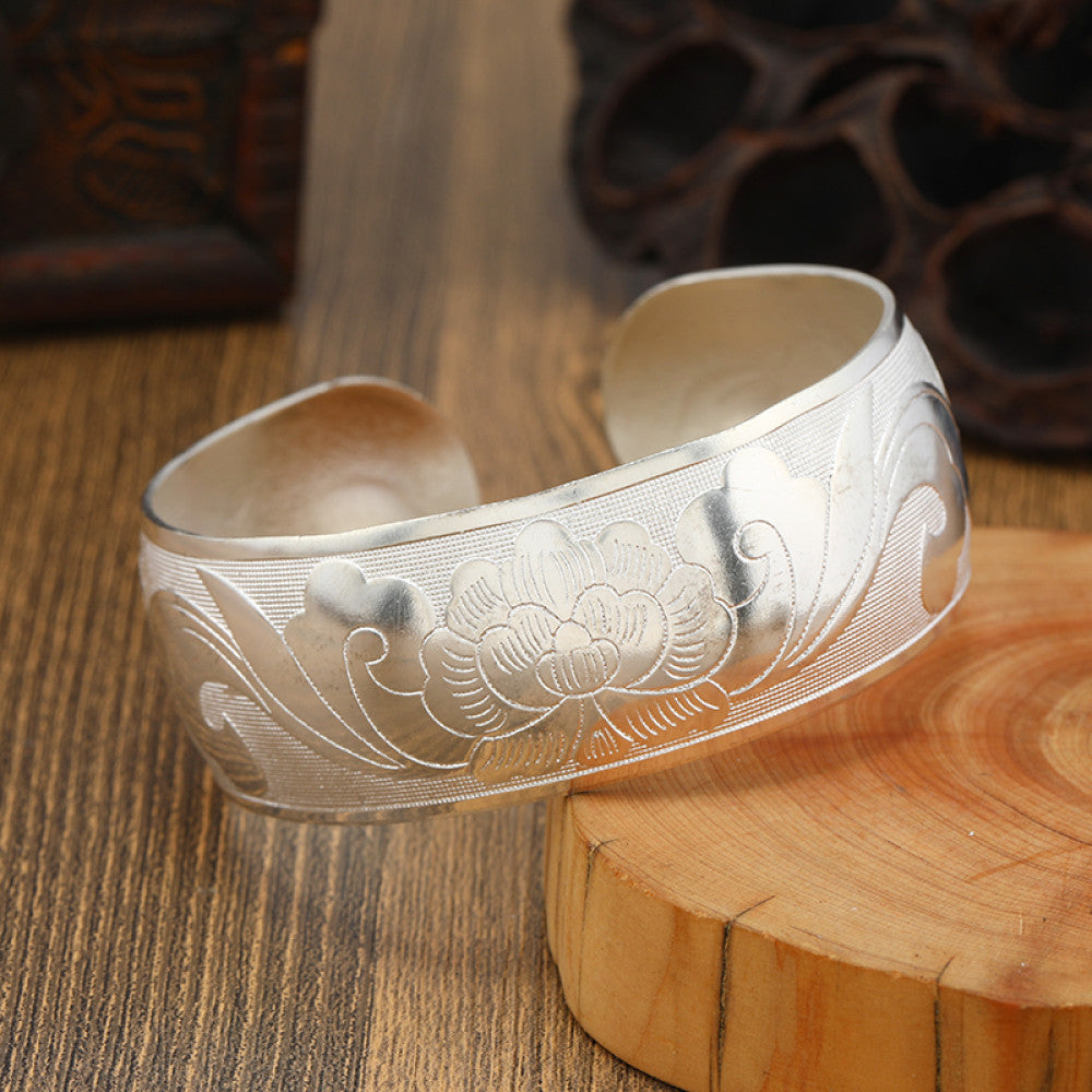 Boho vintage ethnic engraved silver cuff bangle with intricate floral designs, styled on wooden surface, ideal for bohemian and tribal fashion enthusiasts in the US 03
