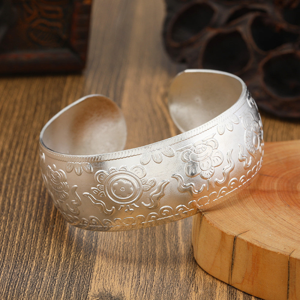 Boho vintage ethnic engraved silver cuff bangle with intricate floral designs, styled on wooden surface, ideal for bohemian and tribal fashion enthusiasts in the US 05