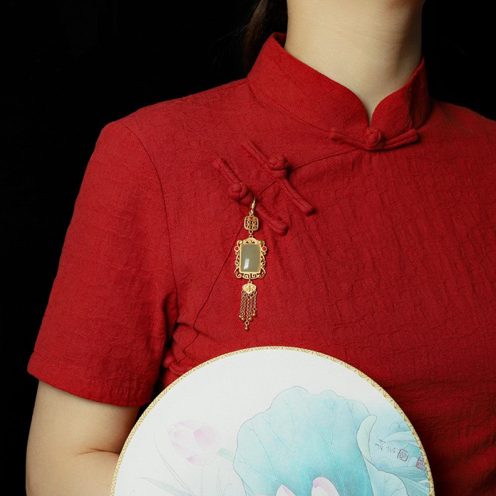 Boho vintage ethnic gold frame jade pendant featuring fu character, red accents and tassel details, styled on a tree branch, ideal for bohemian and traditional fashion enthusiasts in the US 01