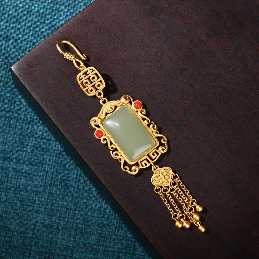 Boho vintage ethnic gold frame jade pendant featuring fu character, red accents and tassel details, styled on a tree branch, ideal for bohemian and traditional fashion enthusiasts in the US 02