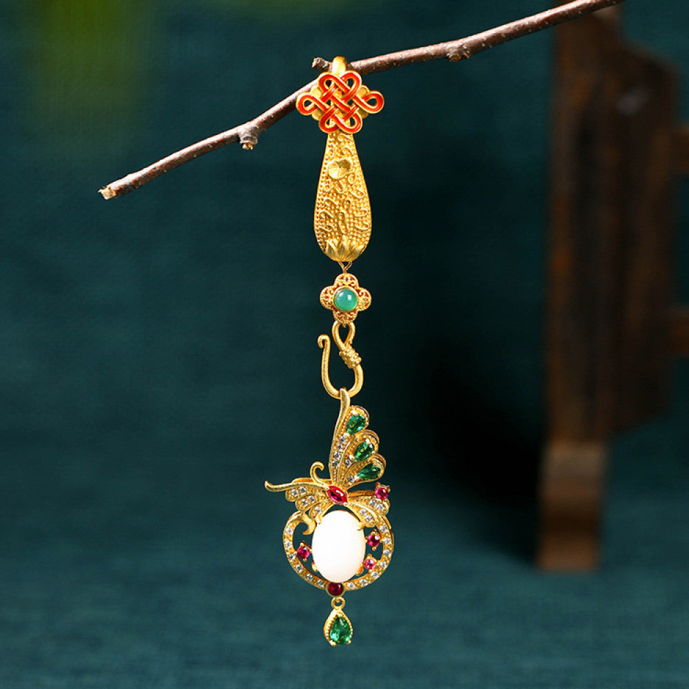 Boho vintage ethnic gold statement pendant featuring Chinese knot, peacock charm and colorful gemstone accents, styled on a tree branch, ideal for bohemian and traditional fashion enthusiasts in the US
