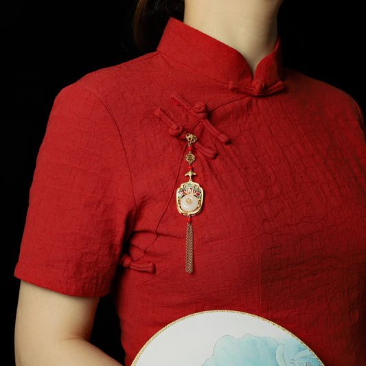 Boho vintage ethnic gold statement pendant featuring fu character, colorful enamel details, white gemstone center and gold tassel, styled on a tree branch, ideal for bohemian and traditional fashion enthusiasts in the US 01