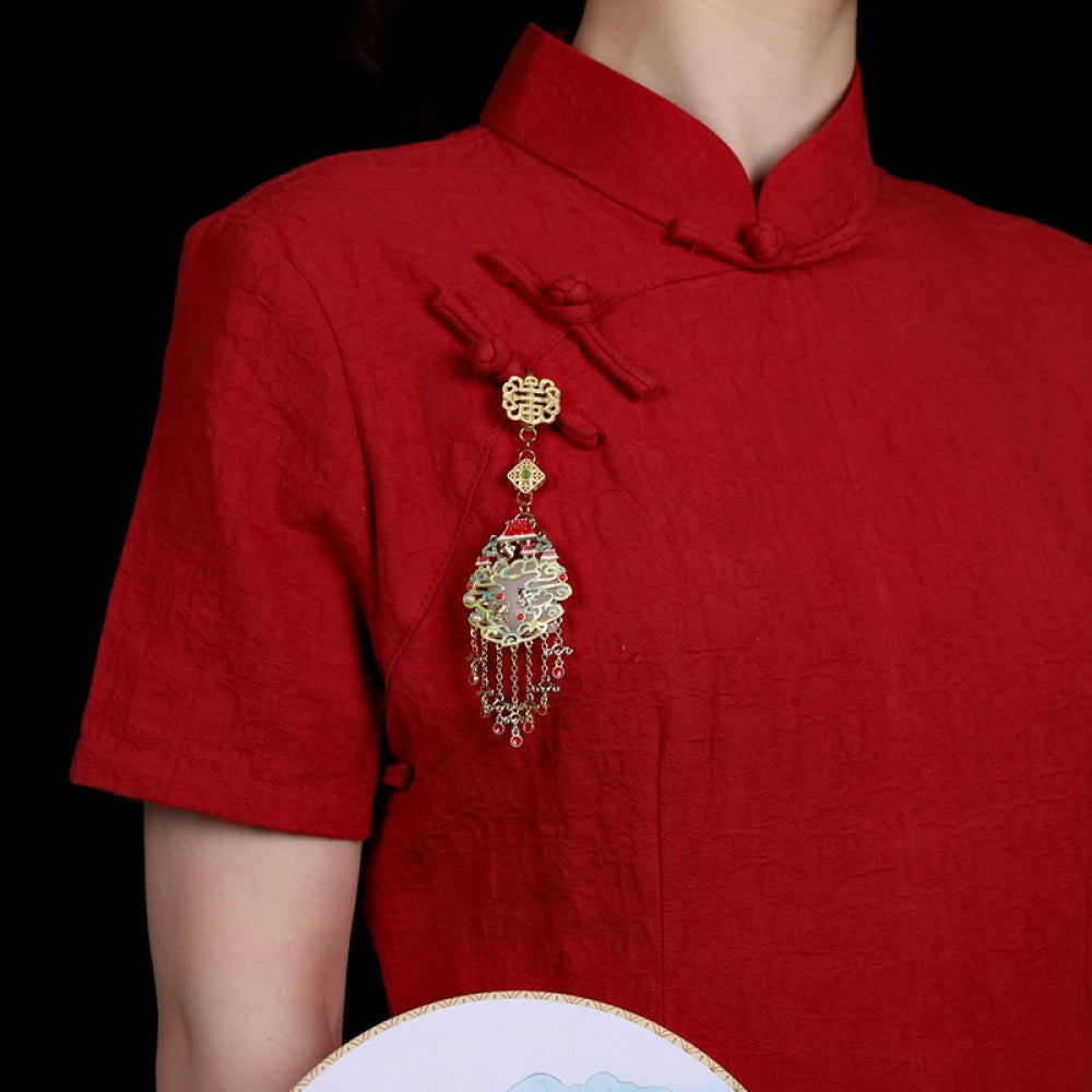 Boho vintage ethnic gold-tone hair pendant featuring intricate Chinese knot clasp, palace-style decorative pendant with red enamel details, and layered red beaded tassels, styled on a wooden display hook against a black background, ideal for bohemian and traditional fashion enthusiasts in the US 01