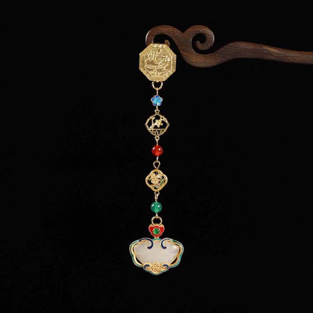 Boho vintage ethnic gold-tone hair pendant featuring intricate gold decorative clasp, blue/red/green gemstone accents, and an enamel-inlaid lock pendant with white texture, styled on a wooden display hook against a black background, ideal for bohemian and traditional fashion enthusiasts in the US