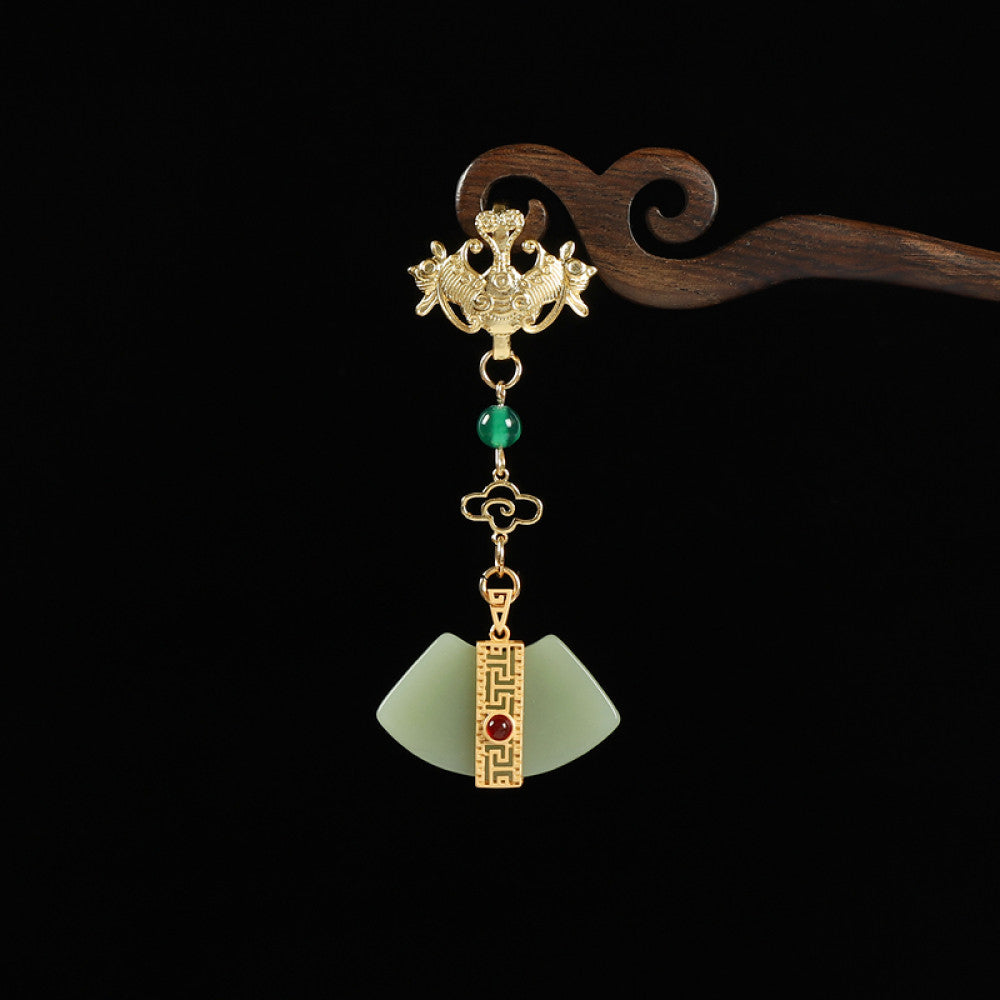 Boho vintage ethnic gold-tone hair pendant featuring phoenix decorative charm, green bead accents, jade fan-shaped pendant with red gemstone detail, styled on a wooden display hook against a black background, ideal for bohemian and traditional fashion enthusiasts in the US