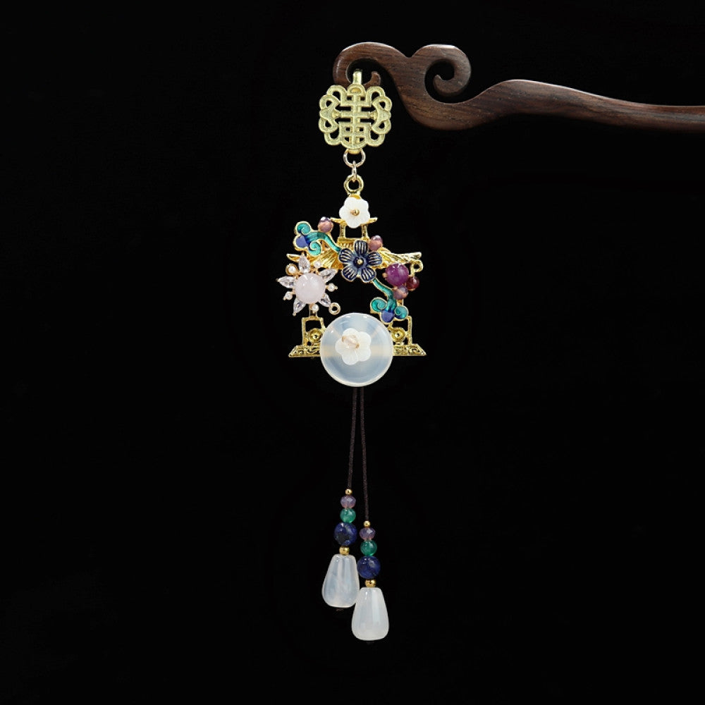 Boho vintage ethnic gold-tone hair pendant featuring double happiness charm, colorful gemstone accents, white jade details and decorative tassels, styled on a wooden display hook, ideal for bohemian and traditional fashion enthusiasts in the US
