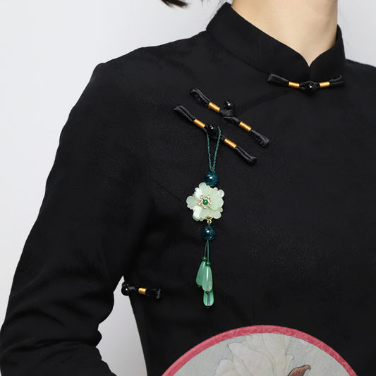 Boho vintage ethnic green-tone hair pendant featuring green cord, dark teal decorative beads, white flower charm (with gemstone center), and light green teardrop pendants, styled against a black fabric background, ideal for bohemian and traditional fashion enthusiasts in the US 02