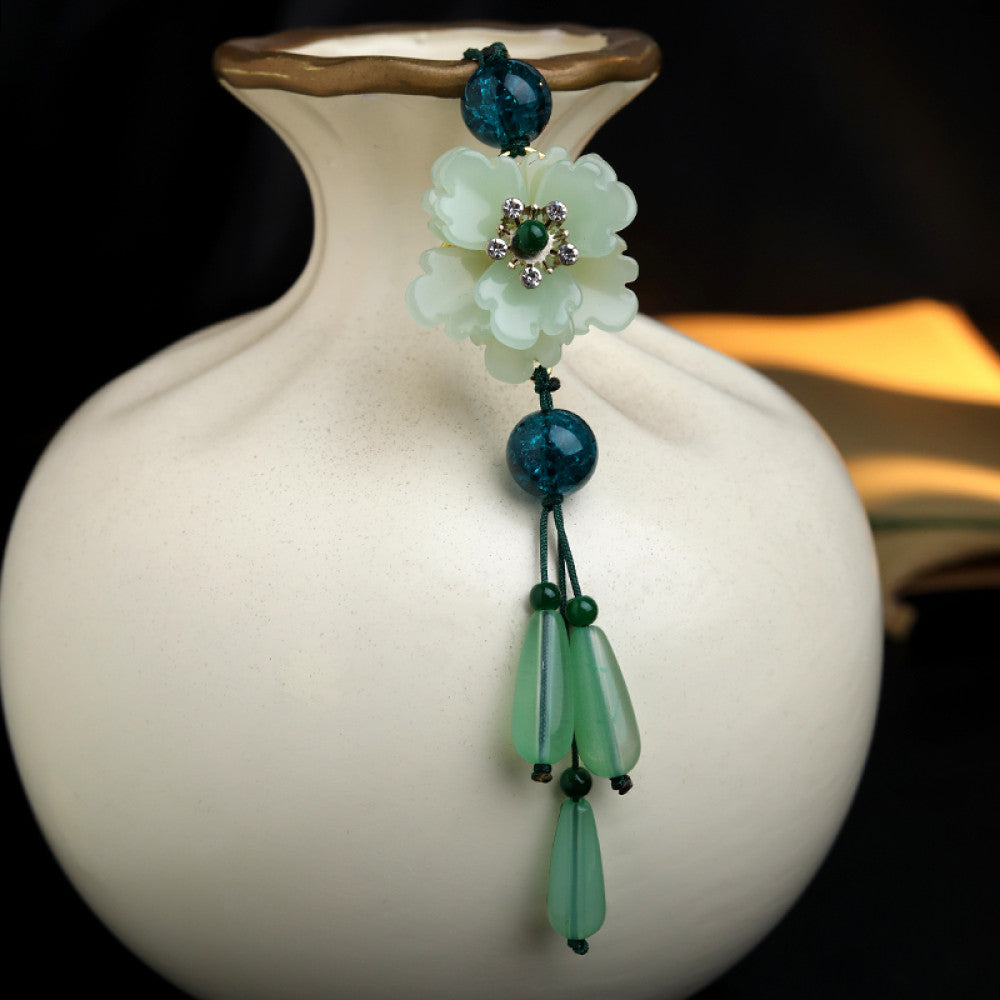 Boho vintage ethnic green-tone hair pendant featuring green cord, dark teal decorative beads, white flower charm (with gemstone center), and light green teardrop pendants, styled against a black fabric background, ideal for bohemian and traditional fashion enthusiasts in the US 03