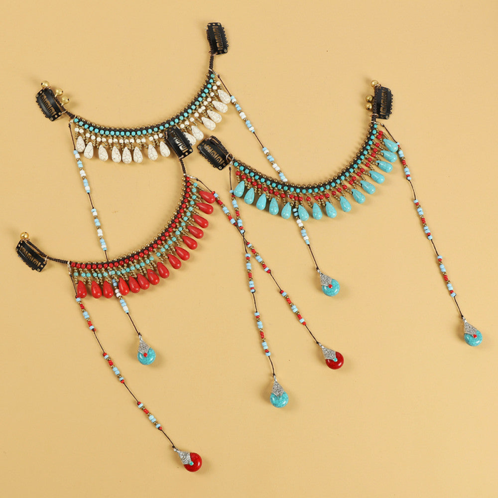 Boho vintage ethnic hair clip ornament featuring red coral-style beads, turquoise accents, and long dangle tassel pendants, displayed on a warm yellow background 01
