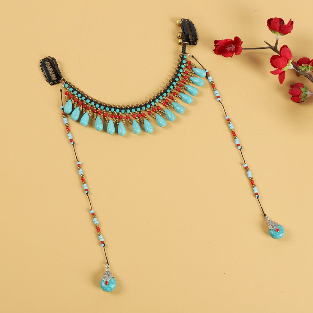 Boho vintage ethnic hair clip ornament (with hair clips) featuring red coral-style beads, turquoise accents, and long dangle tassel pendants, displayed on a warm yellow background (alongside red flower branches), ideal for bohemian traditional fashion styling in the US 01