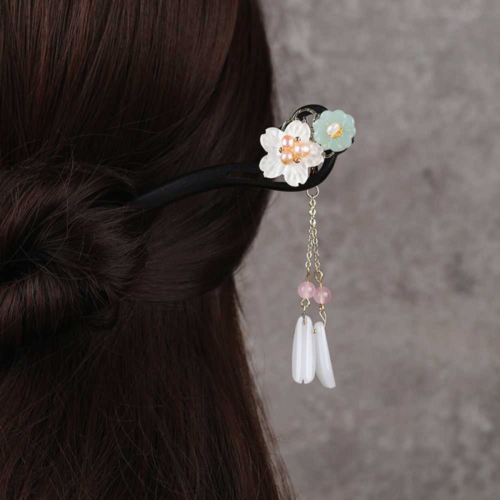 Boho vintage ethnic hair stick ornament featuring a pink flower green leaf accents, pink/green bead tassel, and light green leaf pendant, displayed against a muted gray background 02