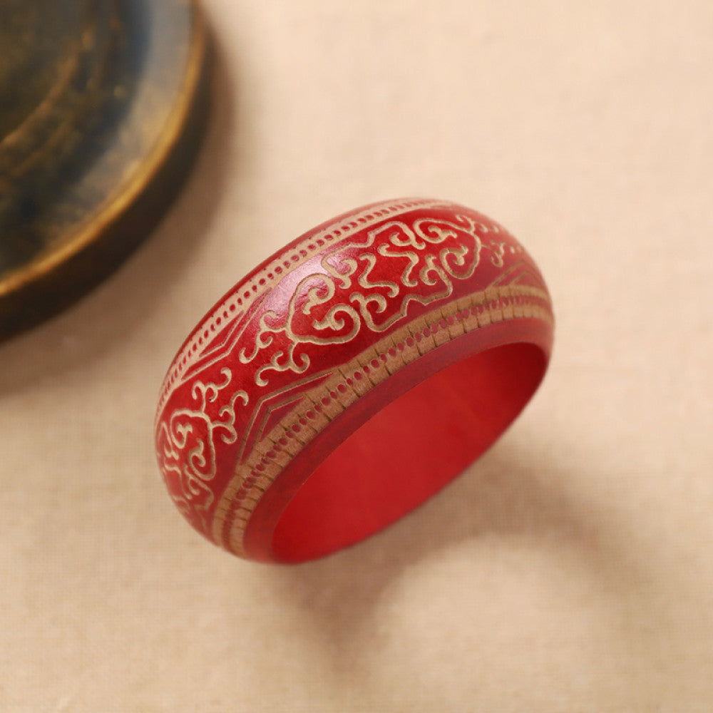 Boho vintage ethnic red bangle with intricate gold filigree designs, styled on neutral surface, ideal for bohemian and ethnic fashion enthusiasts in the US