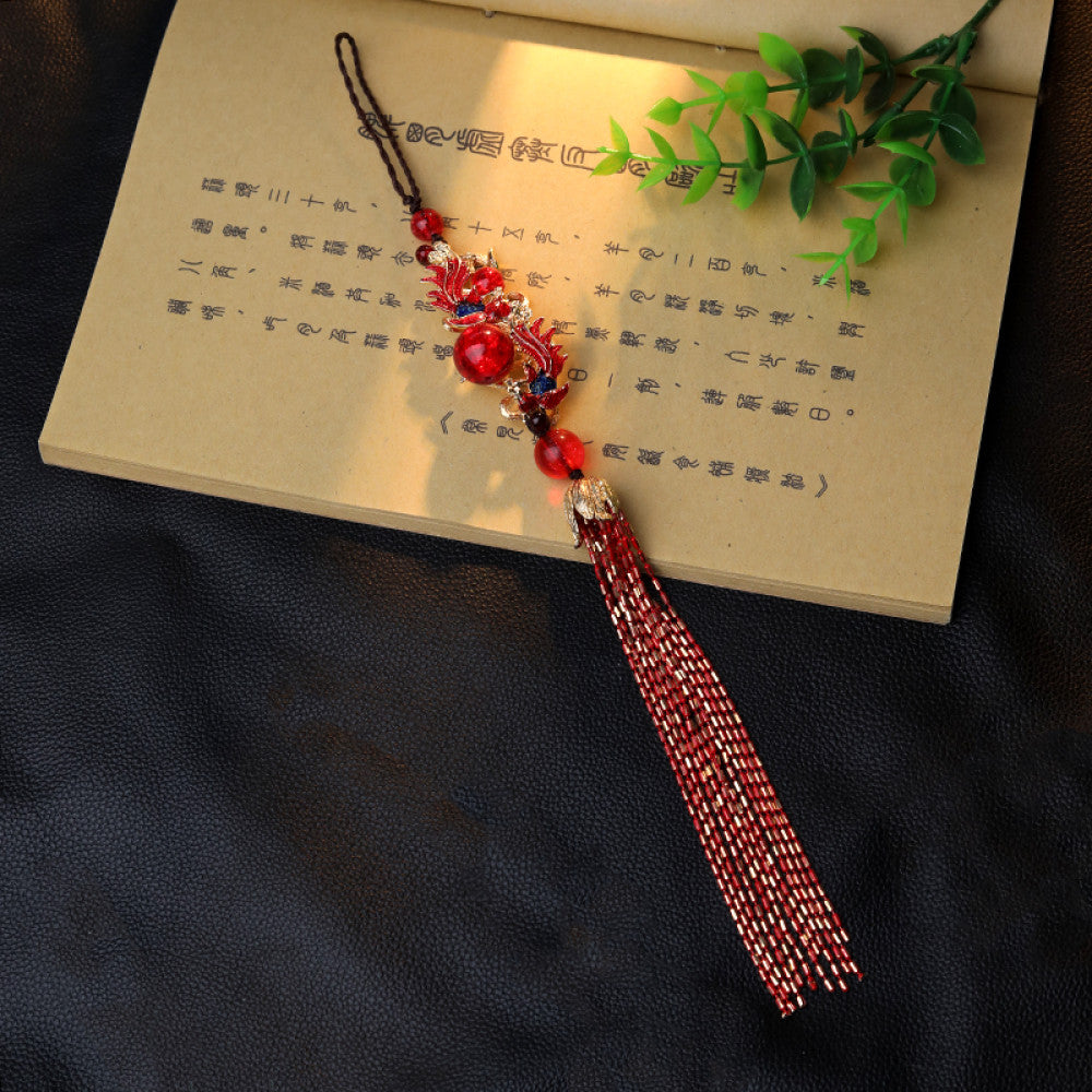 Boho vintage ethnic red-tone hair pendant featuring black cord, intricate red dragon charm (with decorative details), red bead accents, and long red-gold fringe tassels, styled against a black fabric background, ideal for bohemian and traditional fashion enthusiasts in the US 06