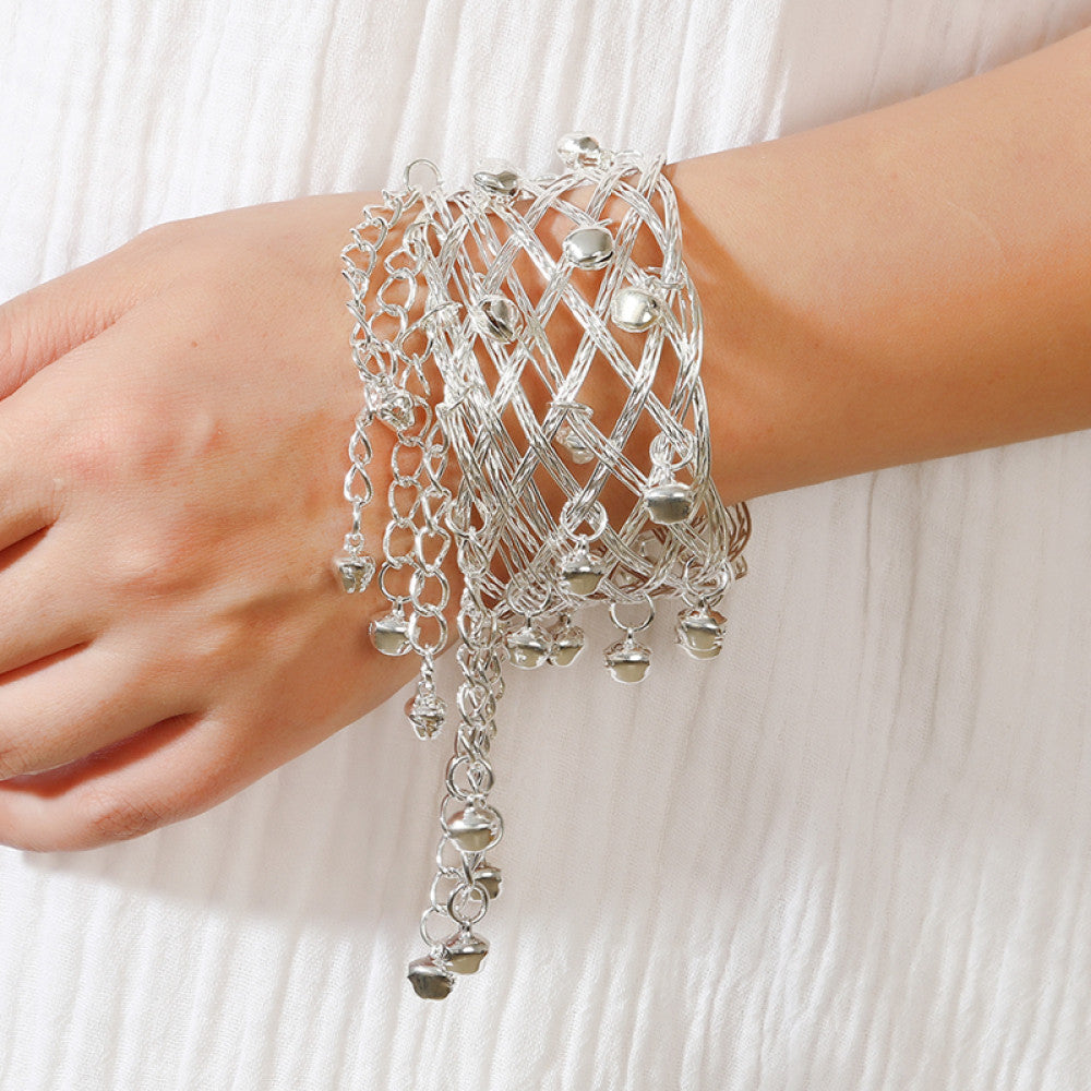 Boho vintage ethnic silver cuff bangle with bell and tassel details, styled on a vintage book, ideal for bohemian and ethnic fashion enthusiasts 01