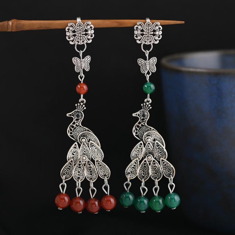 Boho vintage ethnic silver peacock earrings with red and green gemstone beads, styled on a stick, ideal for bohemian and traditional fashion enthusiasts in the US 