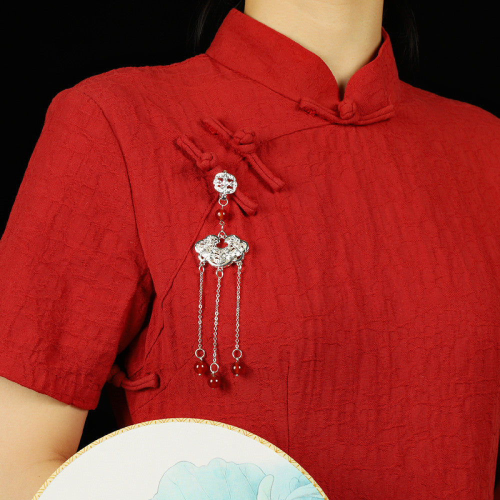 Boho vintage ethnic silver hair pendant with Chinese knot detail, intricate lock charm and red bead tassels, styled on a wooden display hook, ideal for bohemian and traditional fashion enthusiasts in the US 02