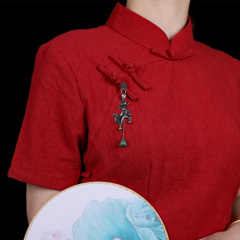 Boho vintage ethnic silver hair pendant featuring fu character detail, opera character-shaped charm and green tassel, styled on a wooden display hook, ideal for bohemian and traditional fashion enthusiasts in the US 01