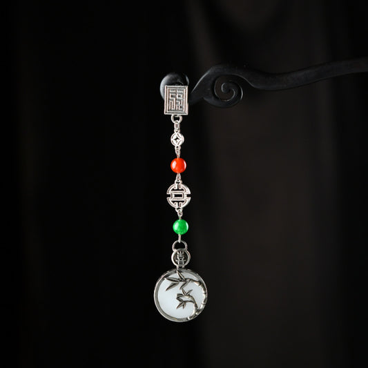 Boho vintage ethnic silver pendant charm featuring fu character, red & green beads, and a carved round plaque, styled on a display hook, ideal for bohemian and traditional fashion enthusiasts in the US