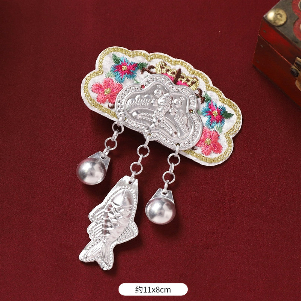 Boho vintage ethnic silver-tone decorative ornament featuring intricate silver-tone detailing, embroidered accent and multiple bell tassel pendants, displayed on a red fabric background 03