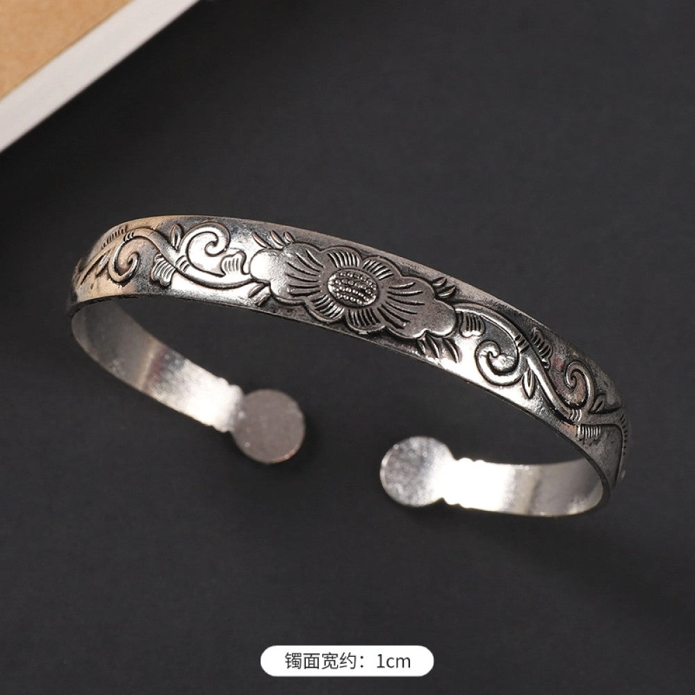 Vintage boho ethnic silver-tone cuff bracelet with dragon and phoenix engravings, styled on a black surface, ideal for bohemian and cultural fashion enthusiasts in the US 02