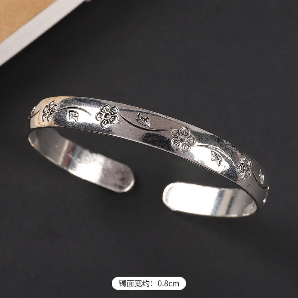 Vintage boho ethnic silver-tone cuff bracelet with dragon and phoenix engravings, styled on a black surface, ideal for bohemian and cultural fashion enthusiasts in the US 04