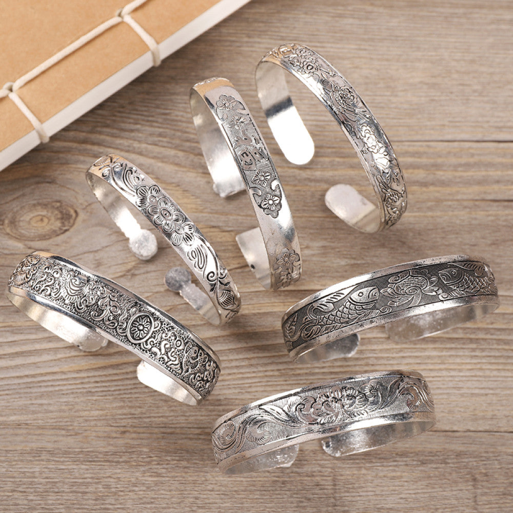 Assorted boho vintage ethnic silver-tone engraved cuff bracelet set, styled on wooden surface, ideal for bohemian and tribal fashion enthusiasts in the US