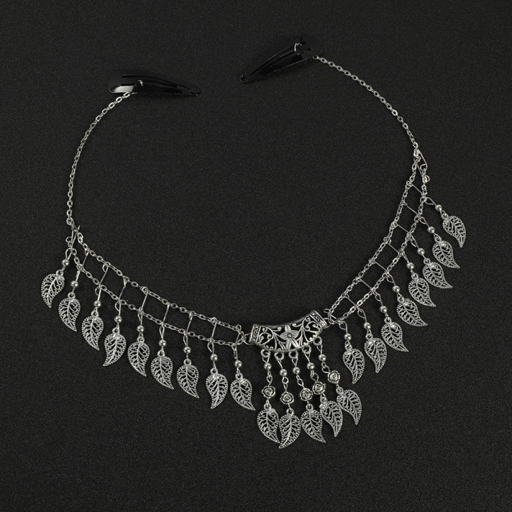 Boho vintage ethnic silver-tone hair clip ornament (displayed on a black background) featuring leaf-shaped dangle fringe and an ornate central decorative piece, ideal for bohemian retro fashion styling in the US