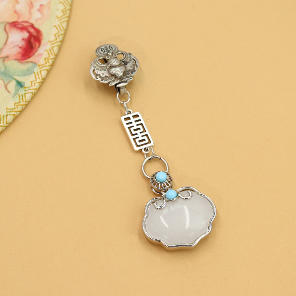 Boho vintage ethnic silver-tone hair pendant featuring lion-shaped decorative clasp, double happiness character detail, light blue bead accent, and a white lock-shaped pendant, styled on a wooden display hook against a black background, ideal for bohemian and traditional fashion enthusiasts in the US 02