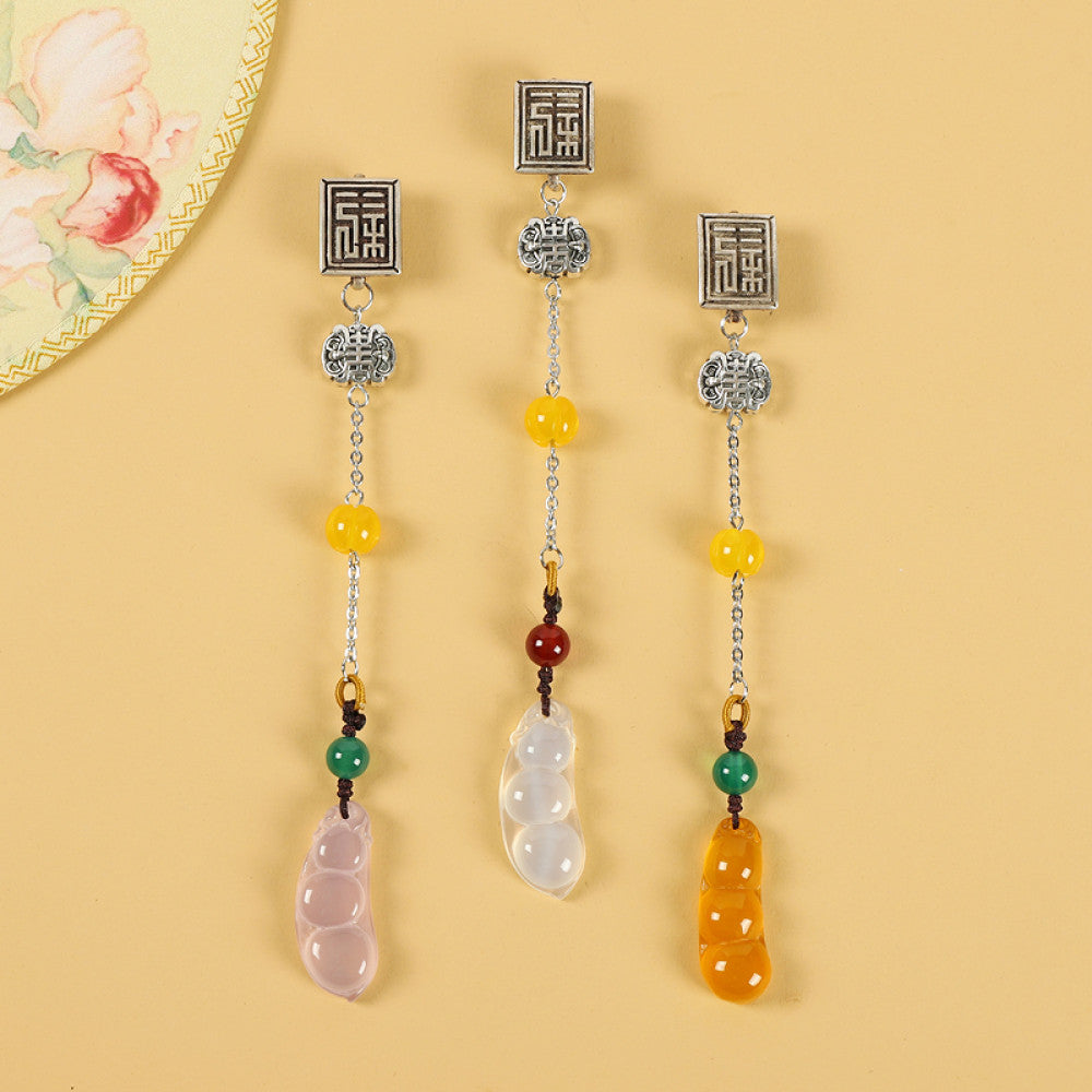 Boho vintage ethnic silver-tone hair pendant set featuring Fu character details, assorted jade bean charms (pink/white/orange) and colorful bead accents, styled on a light yellow background with floral decor, ideal for bohemian and traditional fashion enthusiasts in the US