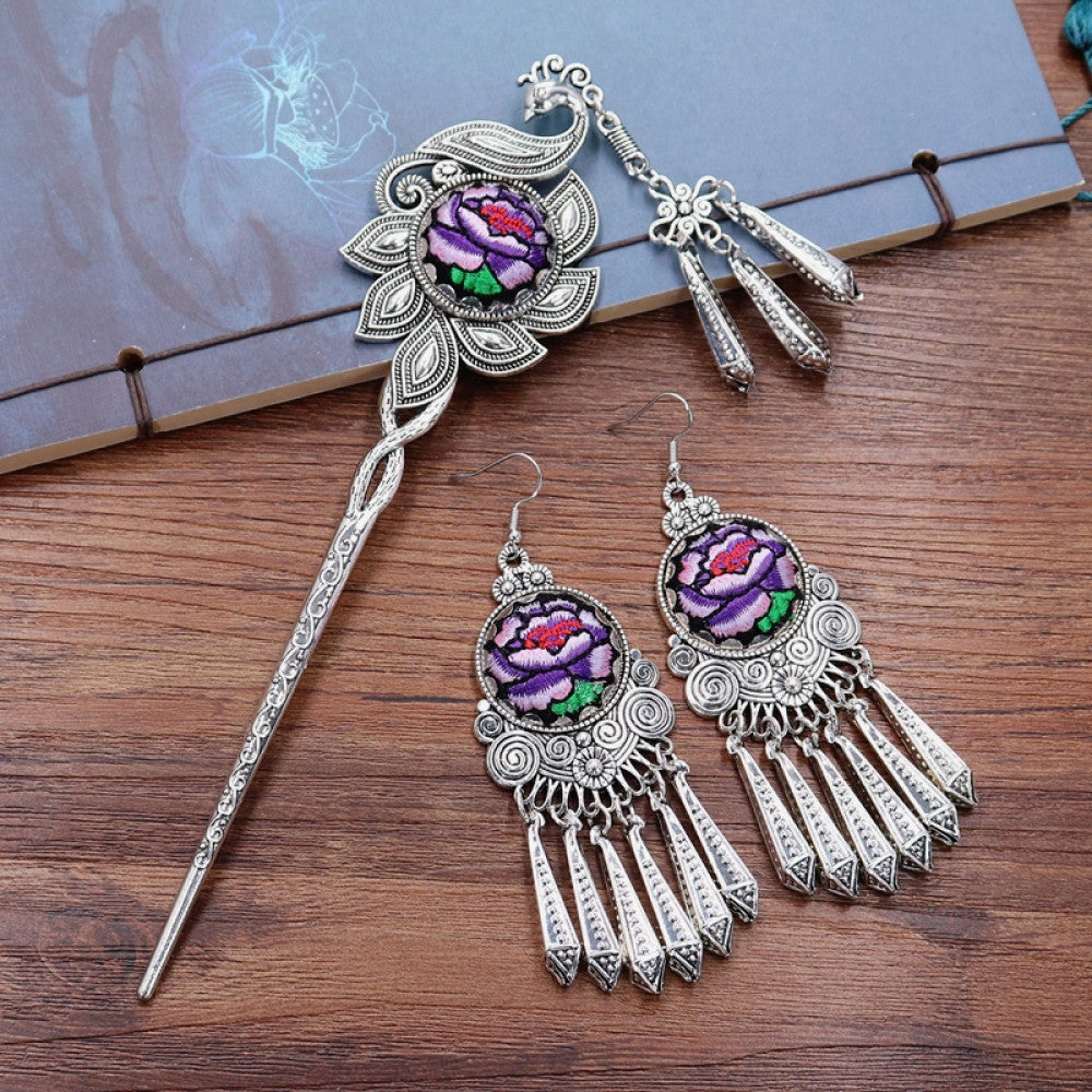 Boho vintage ethnic silver-tone hair stick & earring set (displayed on a wooden surface with a patterned notebook) featuring enamel purple flower details and silver fringe pendants, ideal for bohemian retro or traditional fashion styling in the US