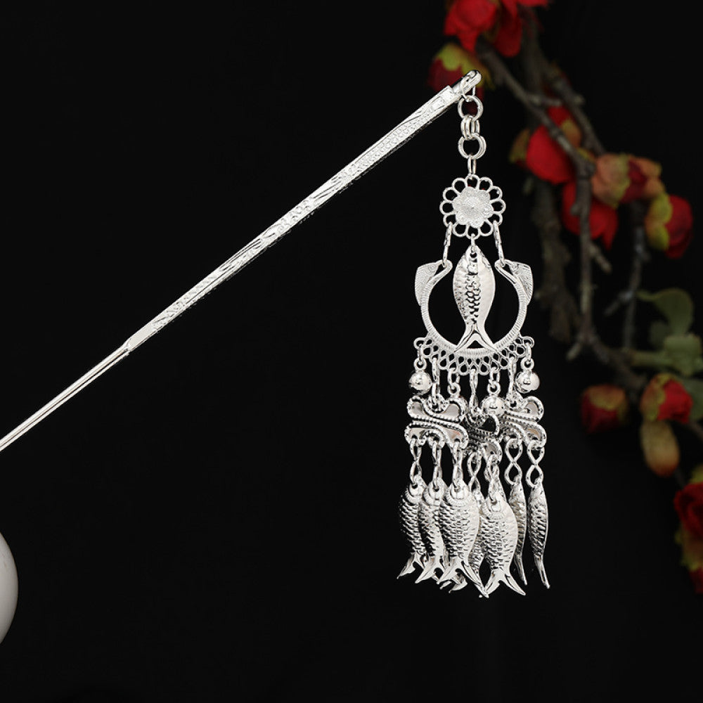 Boho vintage ethnic silver-tone hair stick featuring detailed textured handle, intricate chain network decor, and layered silver tassel pendants, displayed against a black background with red floral accents, ideal for bohemian and traditional fashion enthusiasts in the US 01