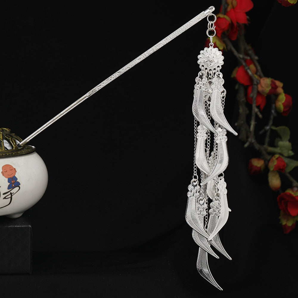Boho vintage ethnic silver-tone hair stick featuring detailed textured handle, intricate chain network decor, and layered silver tassel pendants, displayed against a black background with red floral accents, ideal for bohemian and traditional fashion enthusiasts in the US 03