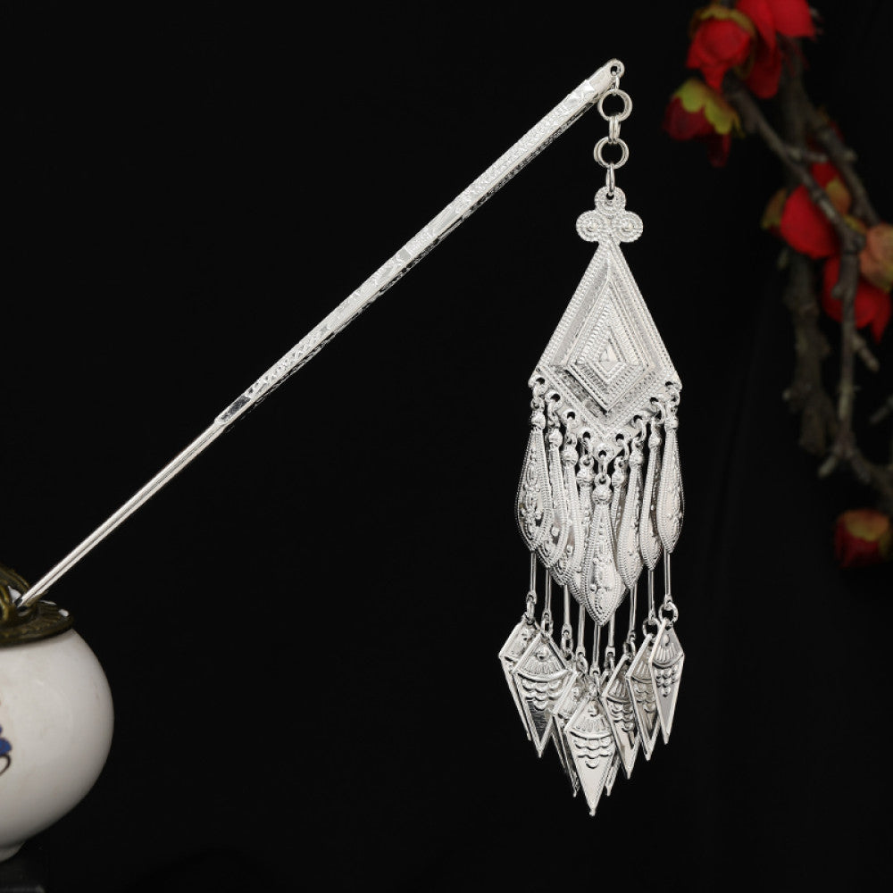 Boho vintage ethnic silver-tone hair stick featuring detailed textured handle, intricate chain network decor, and layered silver tassel pendants, displayed against a black background with red floral accents, ideal for bohemian and traditional fashion enthusiasts in the US 04