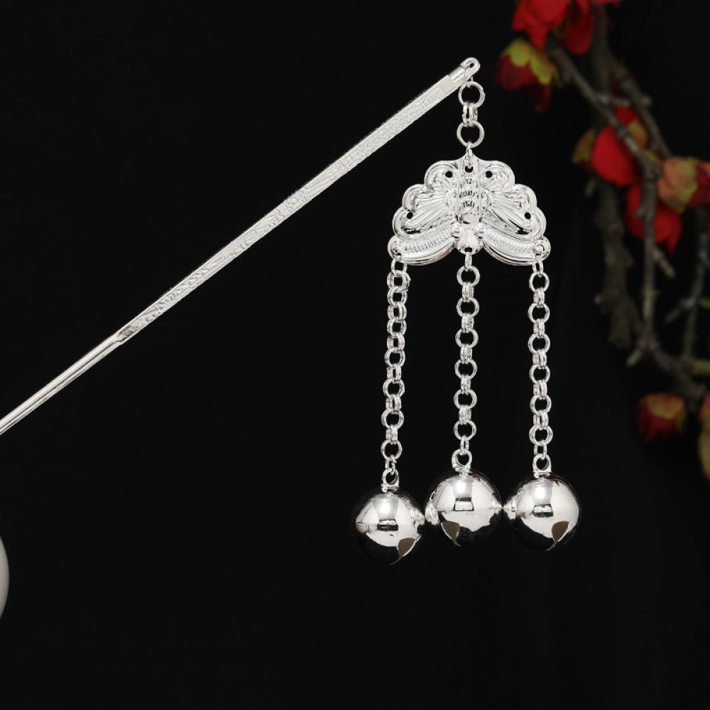 Boho vintage ethnic silver-tone hair stick featuring detailed textured handle, intricate chain network decor, and layered silver tassel pendants, displayed against a black background with red floral accents, 