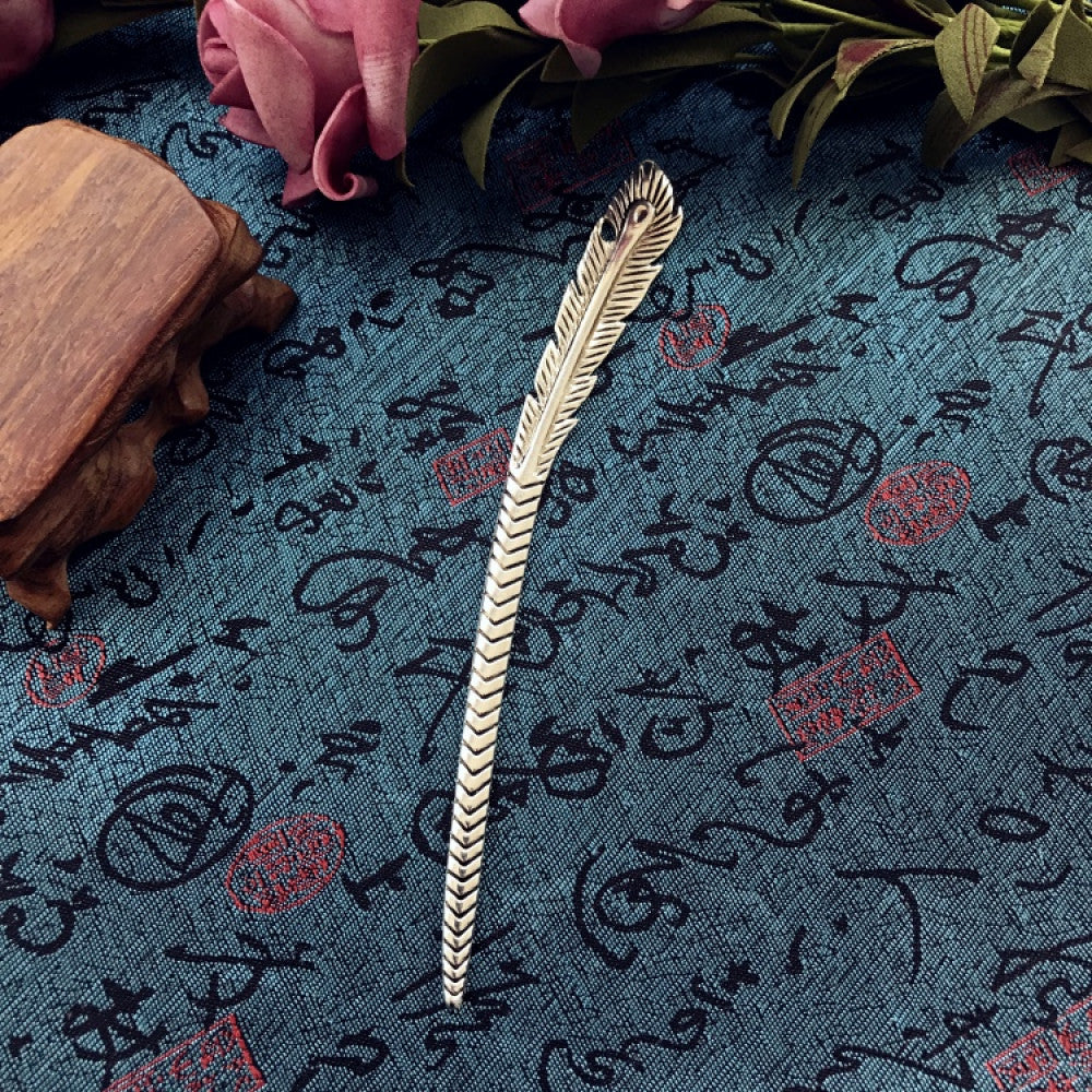 Boho vintage ethnic silver-tone hair stick featuring an intricate curved decorative top, displayed on a blue fabric with text patterns 01