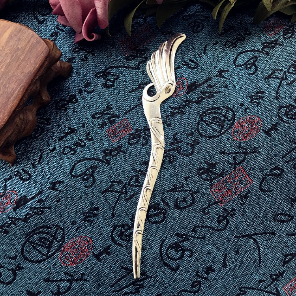 Boho vintage ethnic silver-tone hair stick featuring an intricate curved decorative top, displayed on a blue fabric with text patterns 04