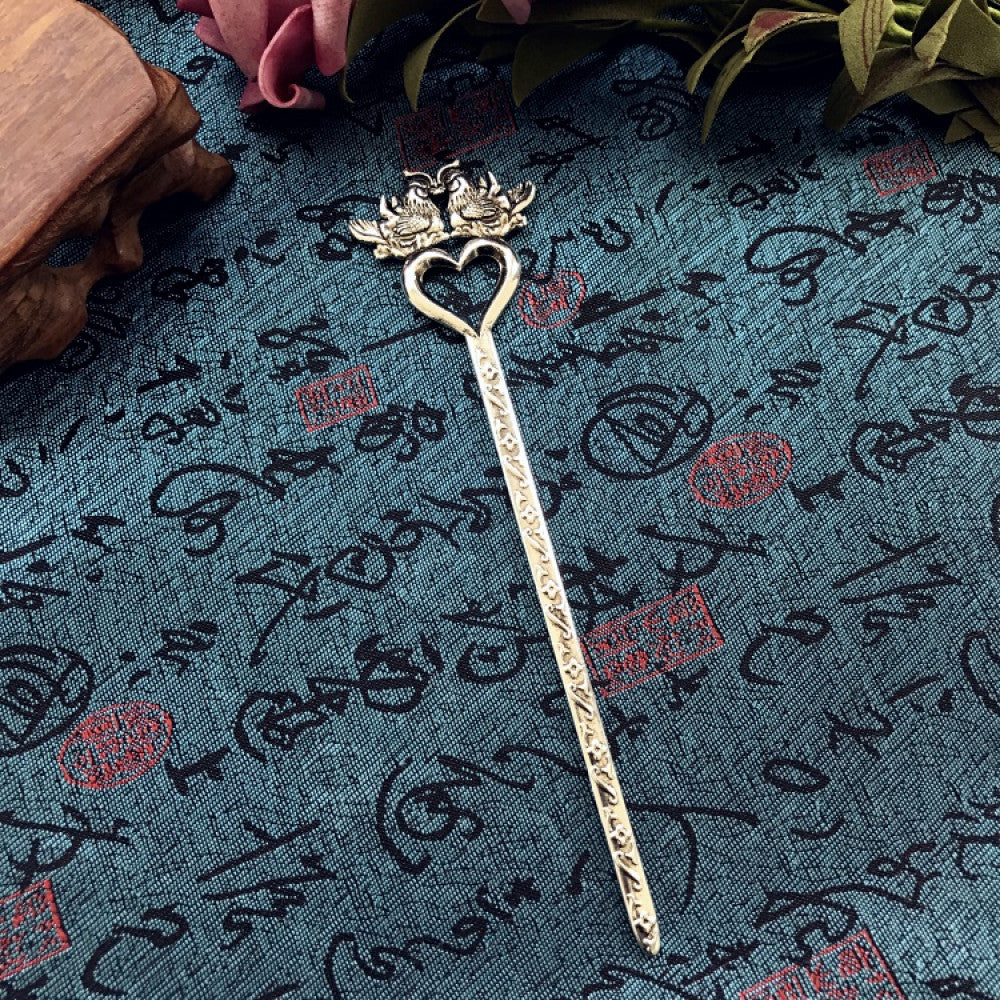 Boho vintage ethnic silver-tone hair stick featuring an intricate curved decorative top, displayed on a blue fabric with text patterns 05