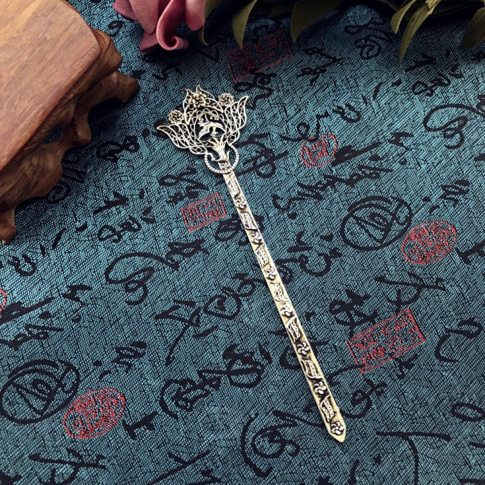 Boho vintage ethnic silver-tone hair stick featuring an intricate curved decorative top, displayed on a blue fabric with text patterns 07