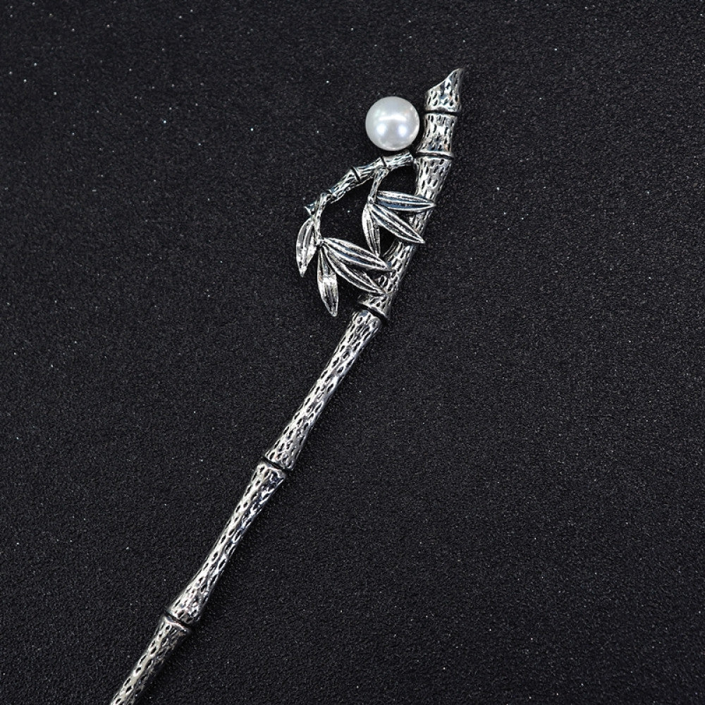 Boho vintage ethnic silver tone hair stick featuring a detailed flower cluster top and ornate carved pattern handle, displayed on a black glittery fabric background 02