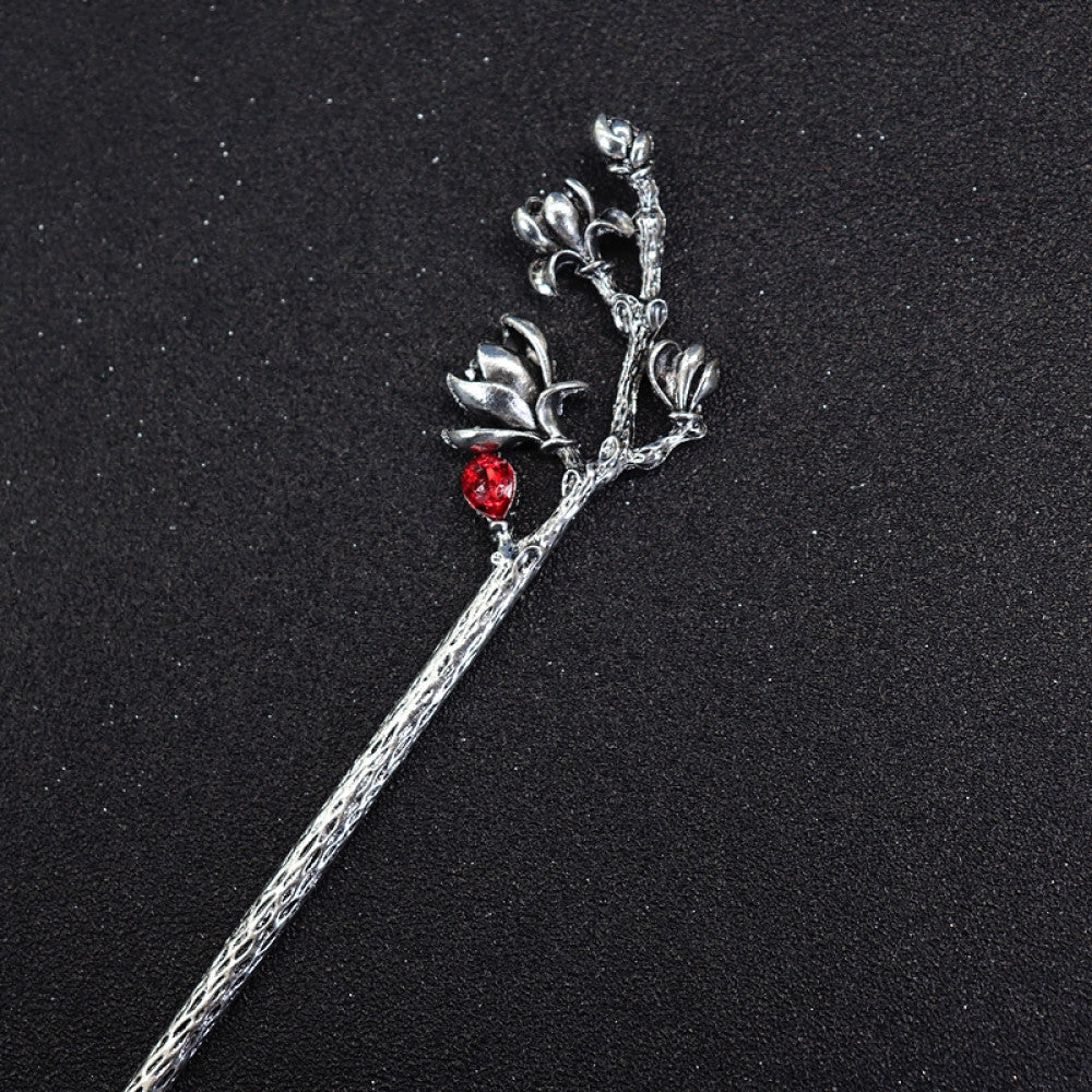 Boho vintage ethnic silver tone hair stick featuring a detailed flower cluster top and ornate carved pattern handle, displayed on a black glittery fabric background 03