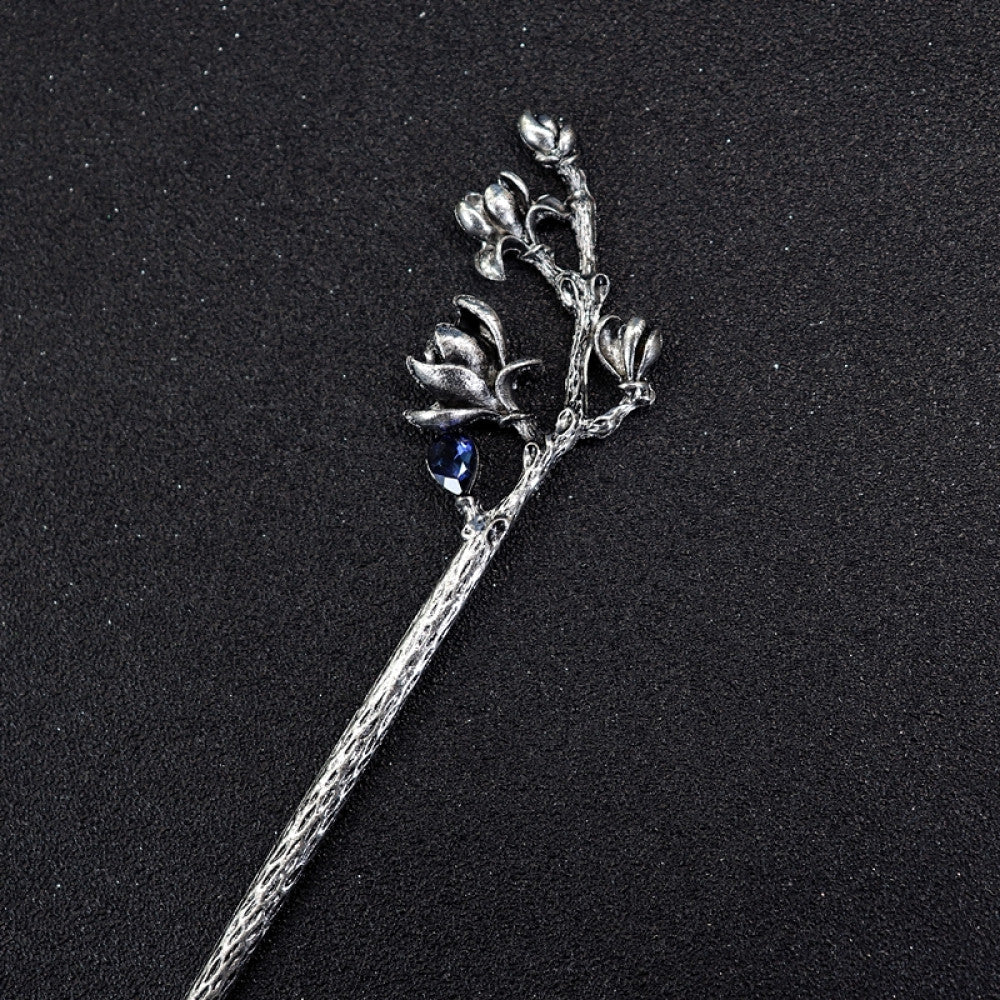 Boho vintage ethnic silver tone hair stick featuring a detailed flower cluster top and ornate carved pattern handle, displayed on a black glittery fabric background 04