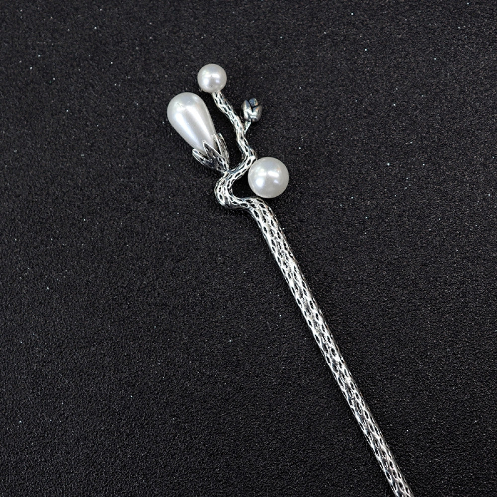 Boho vintage ethnic silver tone hair stick featuring a detailed flower cluster top and ornate carved pattern handle, displayed on a black glittery fabric background 06