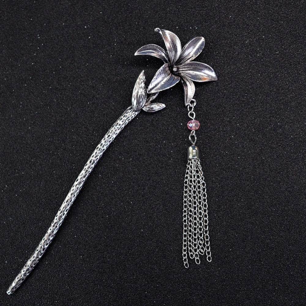 Boho vintage ethnic silver tone hair stick featuring a detailed flower cluster top and ornate carved pattern handle, displayed on a black glittery fabric background 07