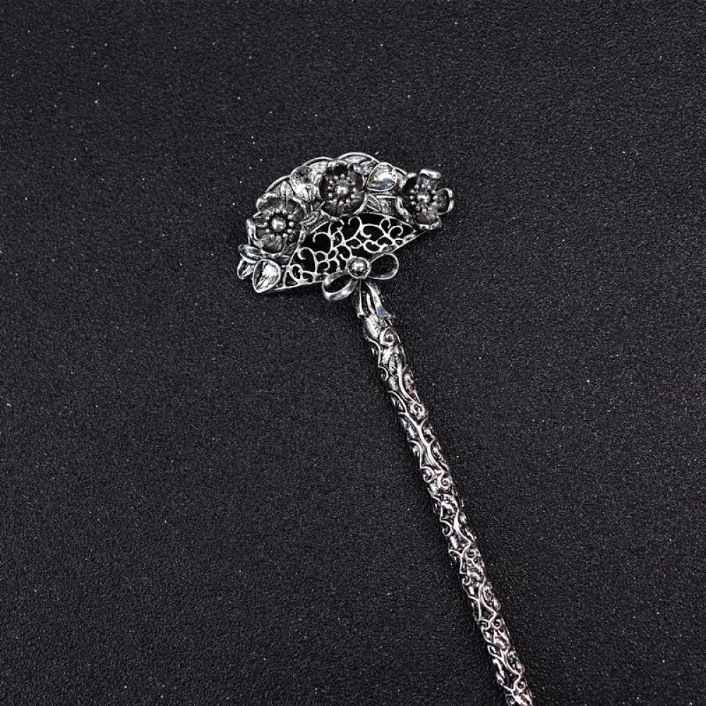 Boho vintage ethnic silver tone hair stick featuring a detailed flower cluster top and ornate carved pattern handle, displayed on a black glittery fabric background, ideal for bohemian and traditional fashion enthusiasts in the US 02
