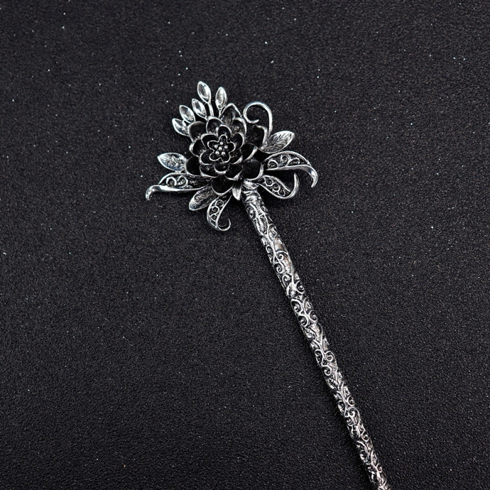 Boho vintage ethnic silver tone hair stick featuring a detailed flower cluster top and ornate carved pattern handle, displayed on a black glittery fabric background, ideal for bohemian and traditional fashion enthusiasts in the US 04