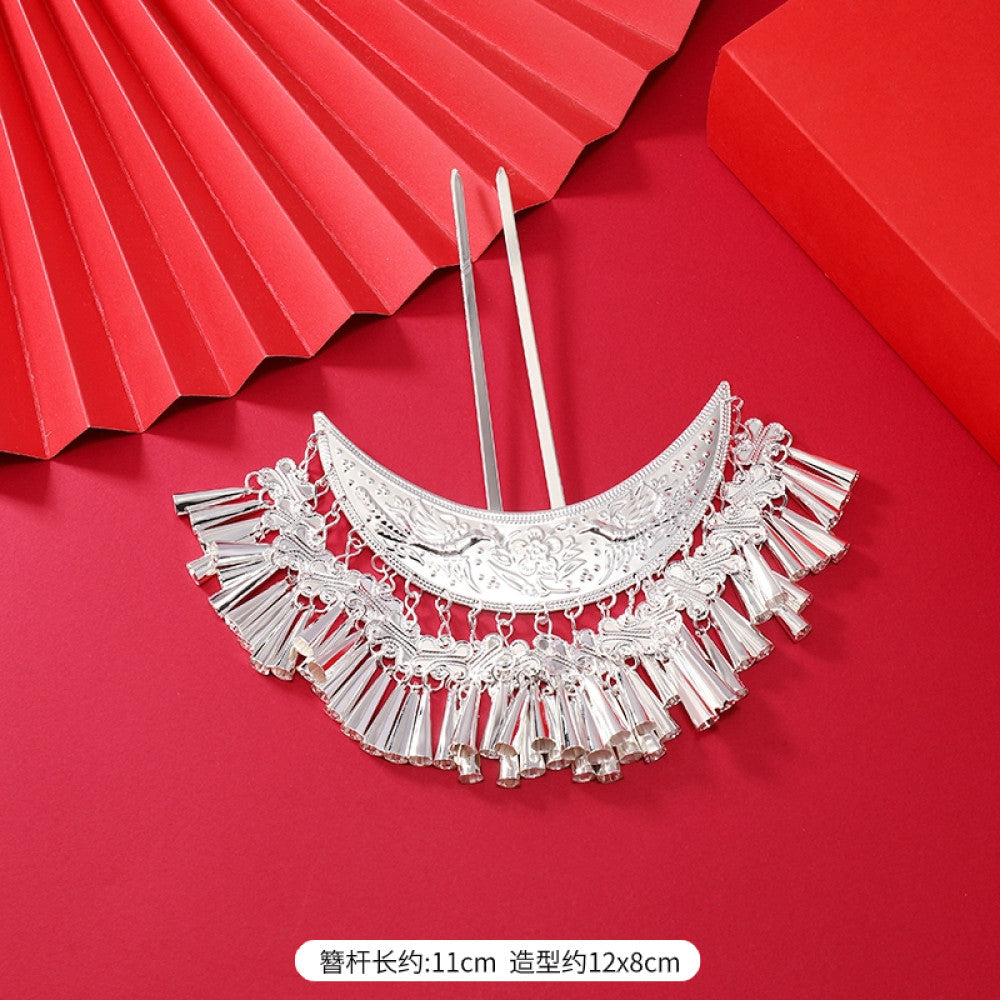 Boho vintage ethnic silver-tone hair stick (hand-held display against a rich red background alongside a red folding fan) featuring intricate openwork details and layered tassel fringe