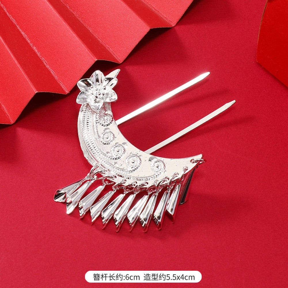 Boho vintage ethnic silver-tone hair stick (hand-held display against a rich red background alongside a red folding fan) featuring intricate openwork details and layered tassel fringe 03