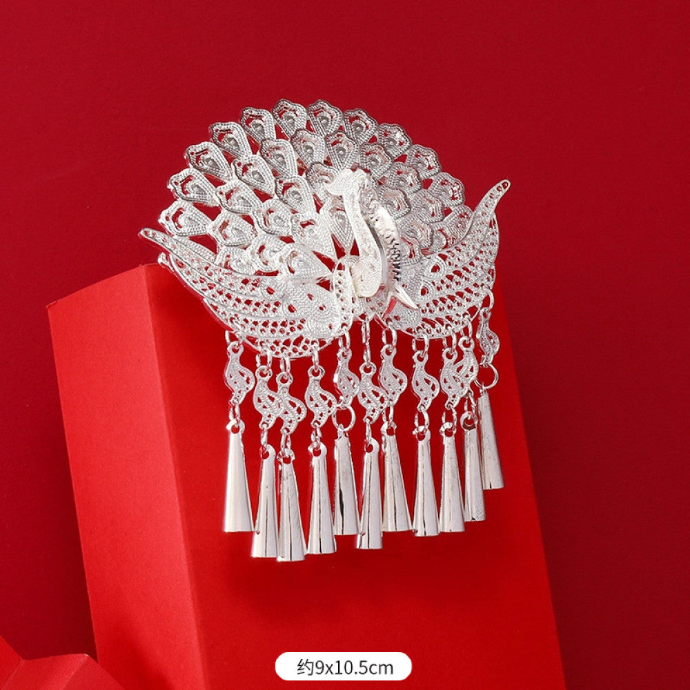 Boho vintage ethnic silver-tone hair stick (hand-held display against a rich red background alongside a red folding fan) featuring intricate openwork details and layered tassel fringe 05